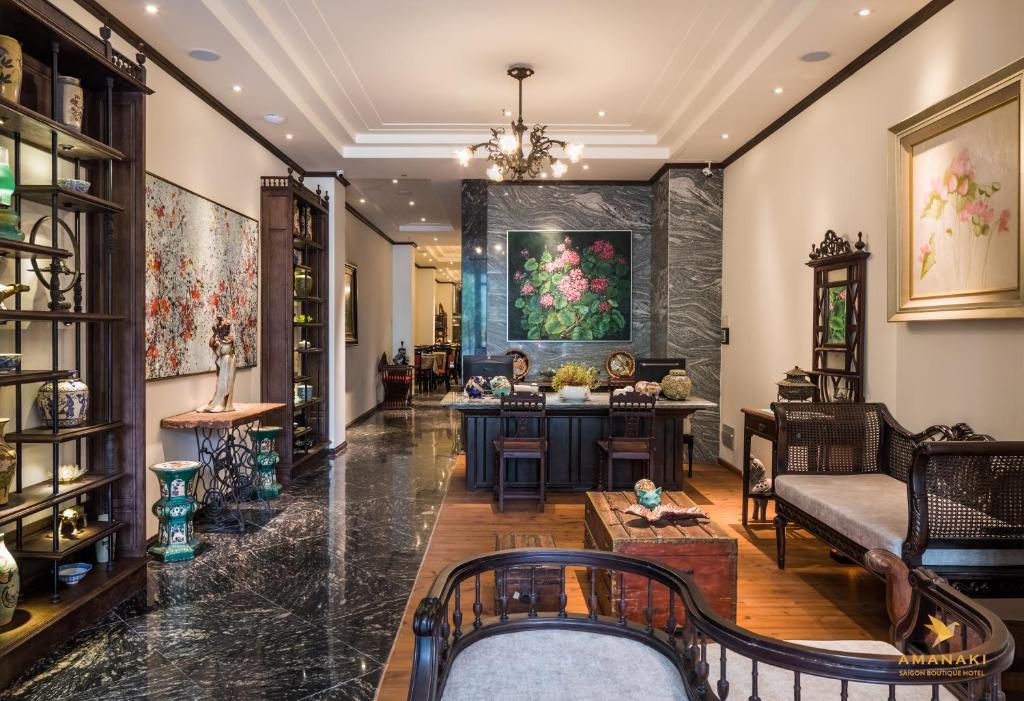 a living room with a table and a couch at Amanaki Saigon Boutique Hotel in Ho Chi Minh City