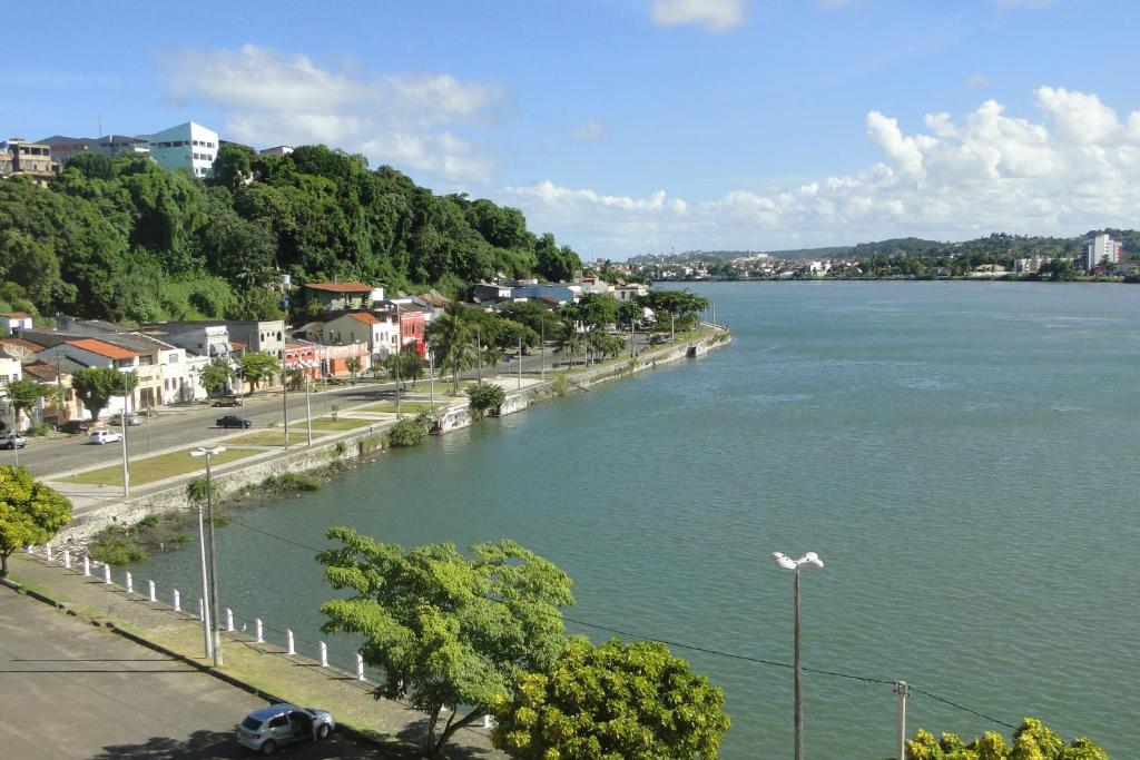 a view of a river with a town and a street at Ilhéus Hotel in Ilhéus