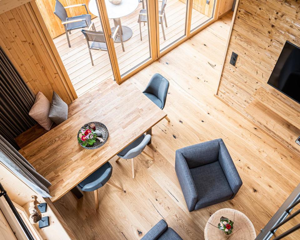 an overhead view of a wooden table and chairs at Nattrars Huimat in Obermaiselstein