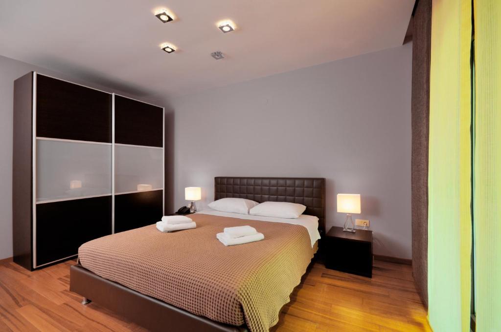 a bedroom with a bed with two towels on it at Sani Polyastron Hotel & Spa in Sani Beach