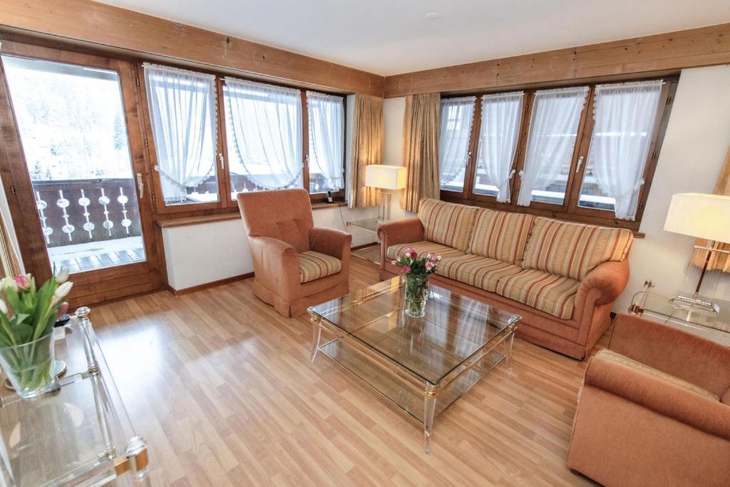 a living room with a couch and a table at Hotel Steinbock in Klosters
