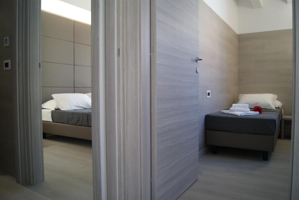A bed or beds in a room at Hotel Residence Sanremo