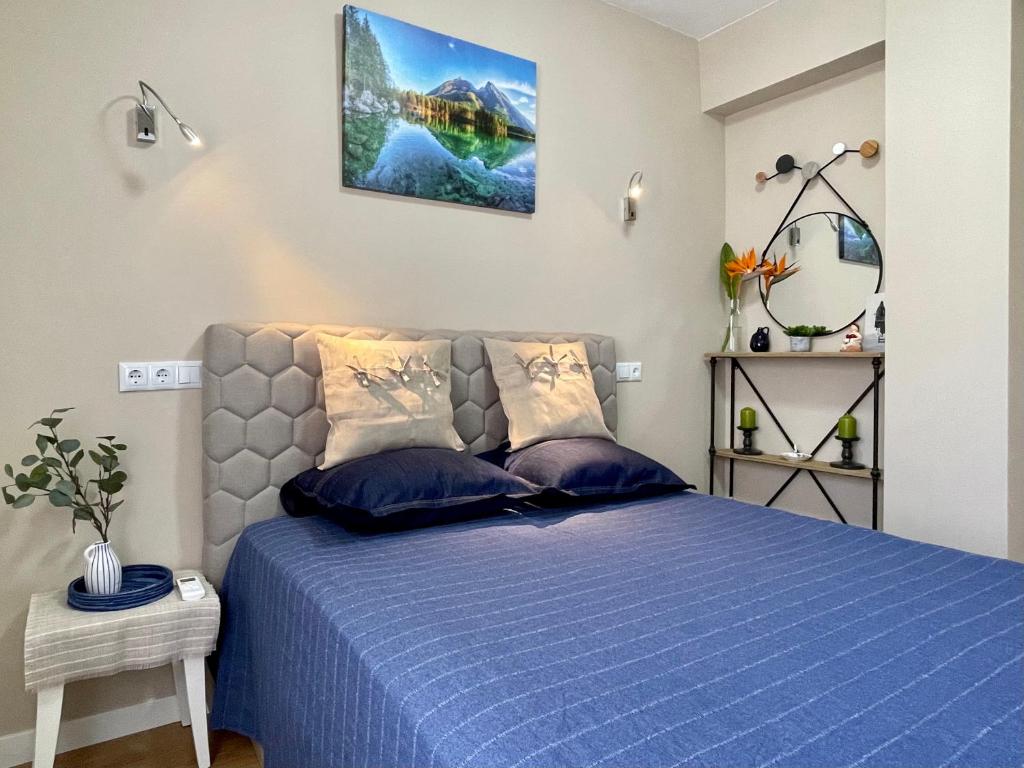 a bedroom with a blue bed with blue pillows at COLIBRI Cómodo, bonito, céntrico in Calpe