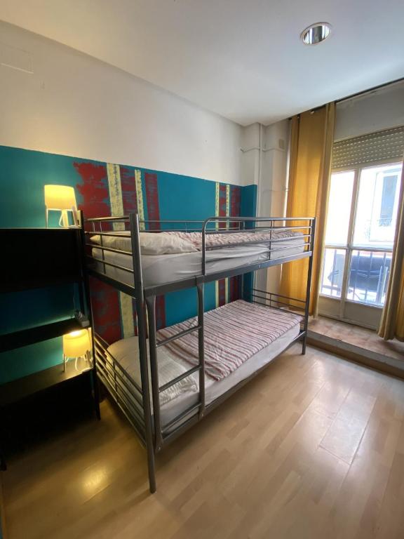 A bed or beds in a room at Bed Madrid Rooms by Bossh! Hotels