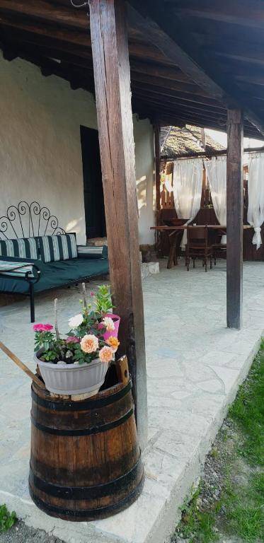 a barrel with a planter with flowers on a patio at STARA KOVAČNICA in Golubac