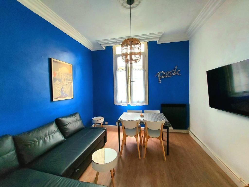 a blue living room with a couch and a table at Appart l'Echappée Belle, Centre Historique, Gare in Montpellier