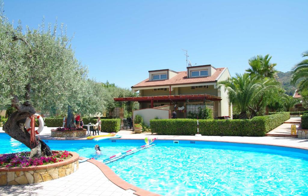 a swimming pool in front of a house at Residence Fontana Barone in Cefalù