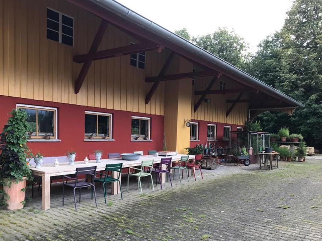 a group of tables and chairs outside of a building at Moorwiesenhof in Ostrach