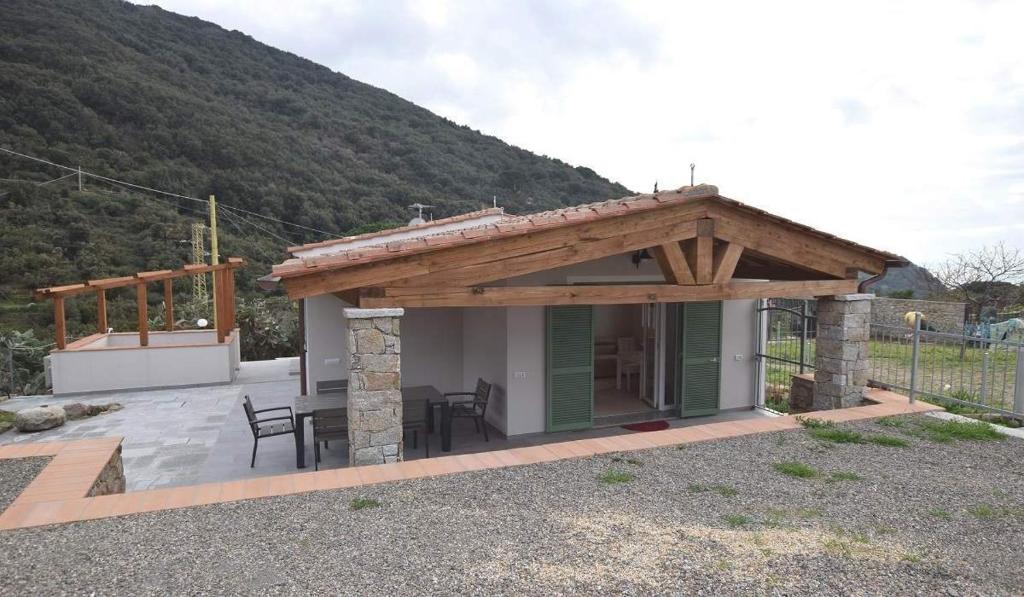 un bâtiment avec un toit en bois et une terrasse dans l'établissement VILLETTA LA ZANCA, à Zanca