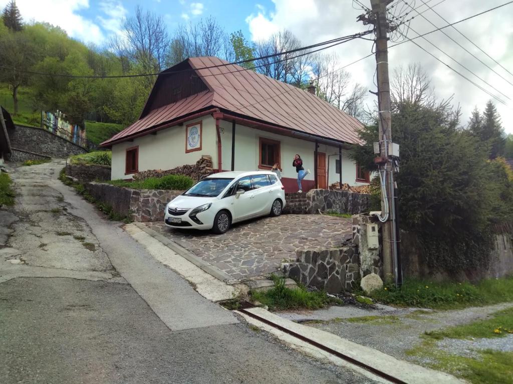 a white car parked in front of a house at Jafura in Dolná Turecká