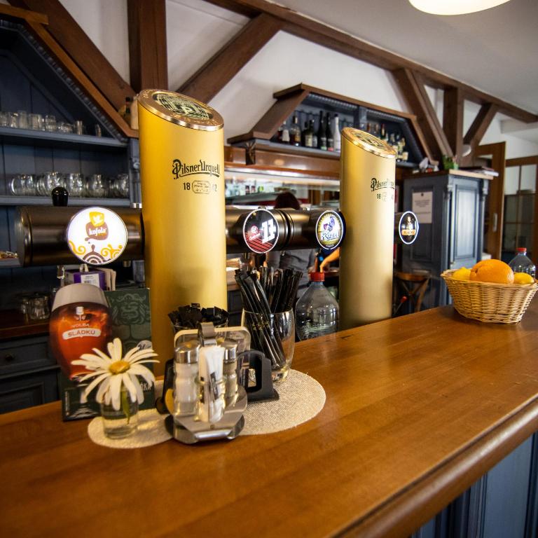 a bar with a counter top with some drinks on it at Hotel U Kata in Kutná Hora