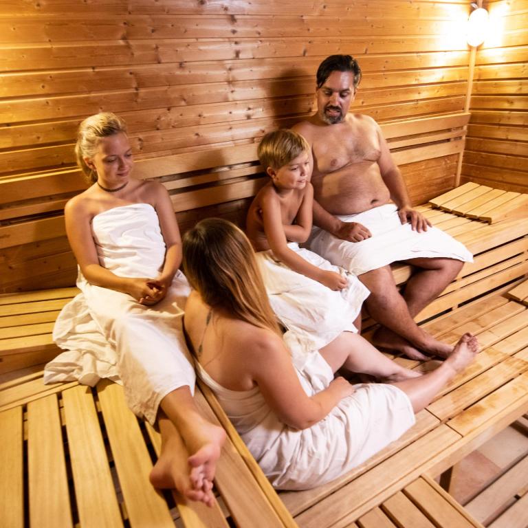 a group of people sitting in a sauna at Hotel U Kata in Kutná Hora