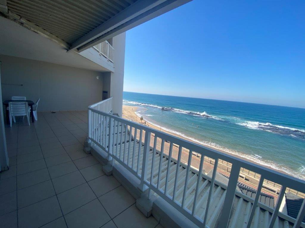 a balcony with a view of the beach at Sorgente 305 in Umdloti