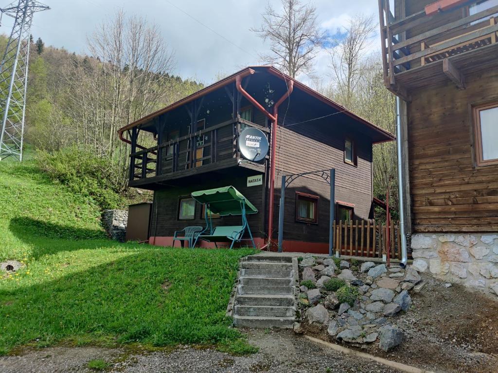 a house with a balcony on the side of it at CHATA NATAŠA in Dedinky