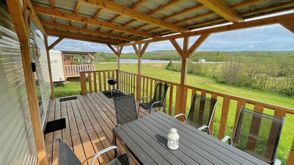 una terraza de madera con mesa y sillas de madera en Mobilheim Willerby Summer - Vyrovická přehrada en Znojmo