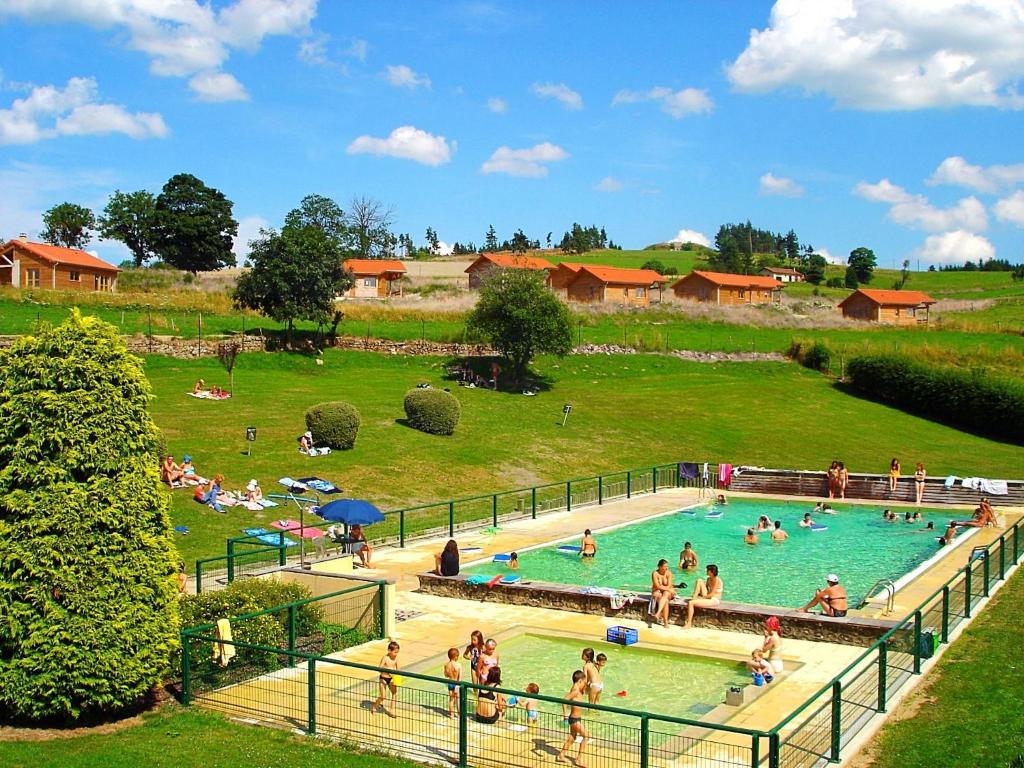 a group of people in a swimming pool in a field at Bel'Horizon in Saint-Pal-en-Chalençon