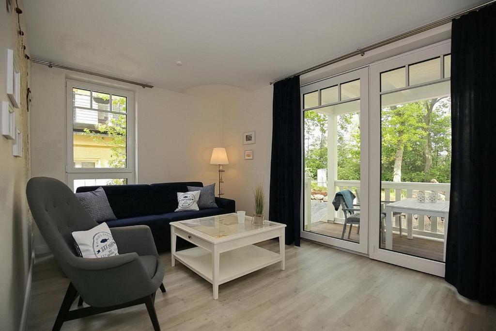 a living room with a couch and a table at Strandvilla Scholle - Dorsch Wohnung 02 in Boltenhagen