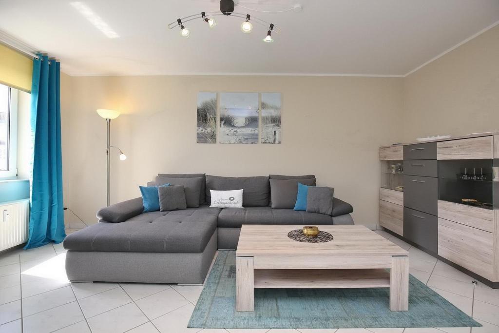 a living room with a couch and a coffee table at Sünnslag Wohnung 092 in Boltenhagen