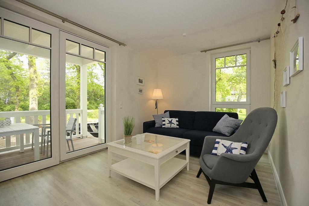 a living room with a couch and a table at Strandvilla Scholle - Lachs Wohnung 01 in Boltenhagen