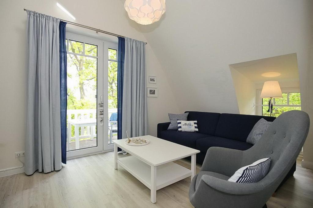 a living room with a couch and a table at Strandvilla Scholle - Scholle Wohnung 05 in Boltenhagen