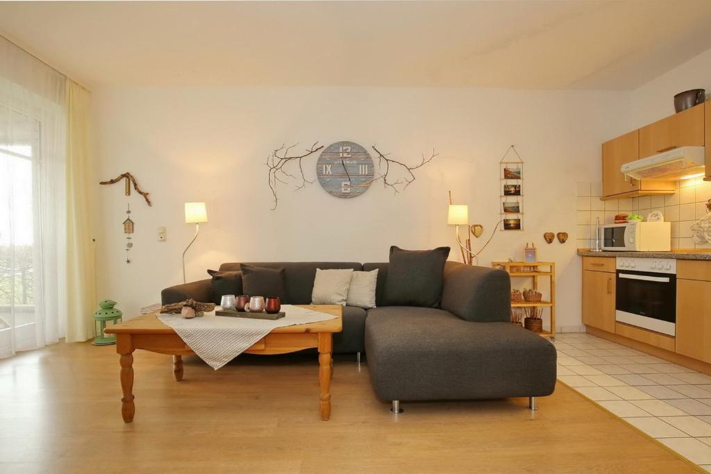 a living room with a couch and a table at Dünenblick Wohnung 05 in Boltenhagen