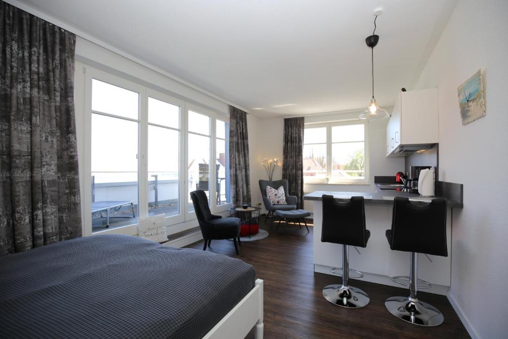 Cet appartement comprend une chambre avec un lit, une cuisine et un salon. dans l'établissement Dünenblick Wohnung 34, à Boltenhagen