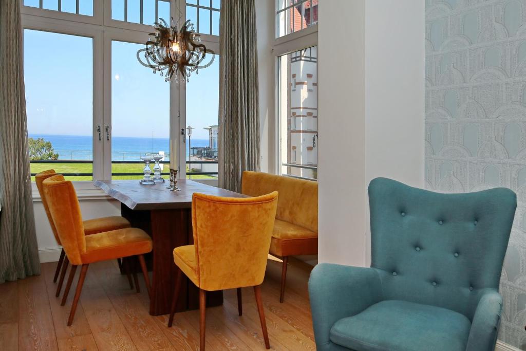 uma sala de jantar com uma mesa e cadeiras e uma janela em Villa Rheingold - Wellgunde Wohnung 1b em Kühlungsborn