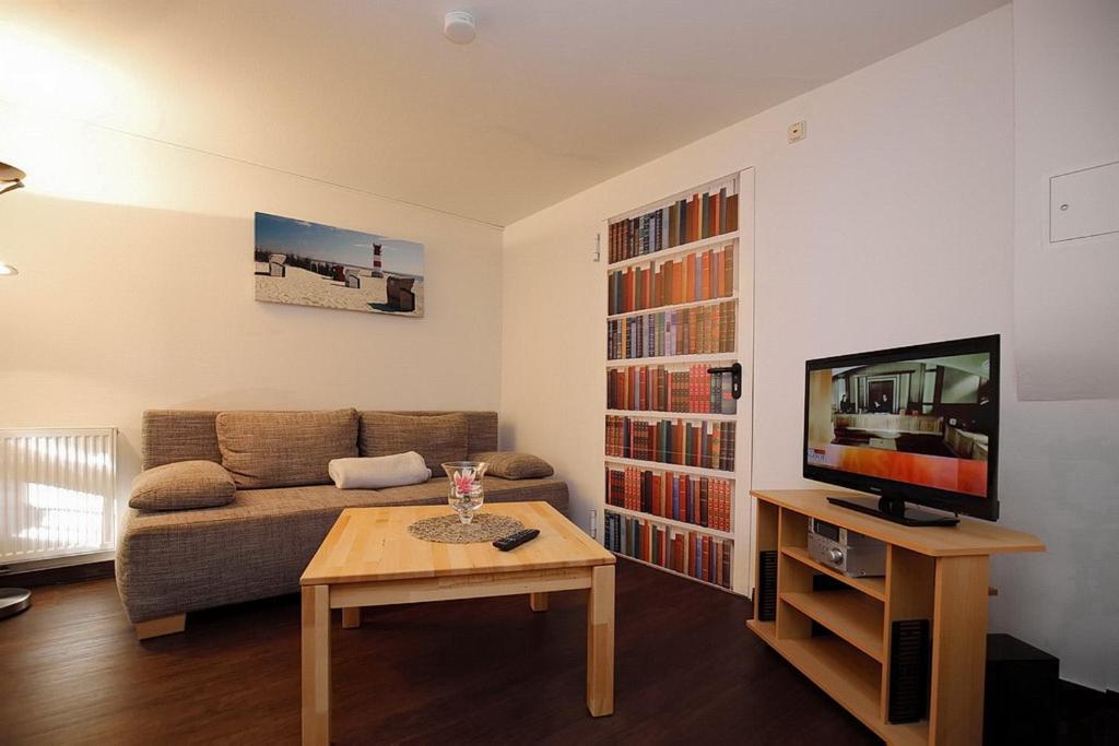 a living room with a couch and a coffee table at Strandvilla Krabbe Wohnung 01 in Boltenhagen