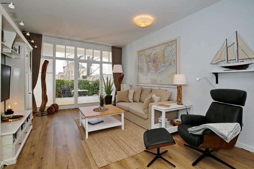a living room with a couch and a table at Meeresblick Wohnung 005 - 4 Sterne DTV in Kühlungsborn