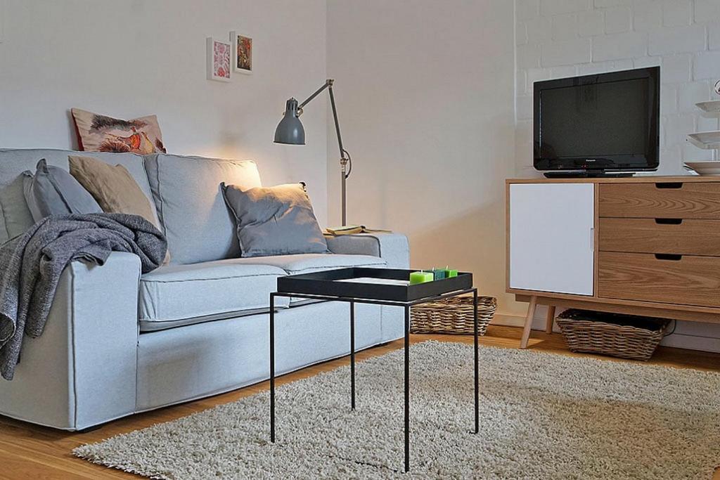 sala de estar con sofá y mesa con TV en Auf den Höfen Wohnung 02, en Kühlungsborn
