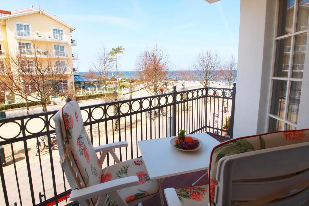 a balcony with a table and chairs and a view of the ocean at Atlantik Wohnung 108 in Kühlungsborn