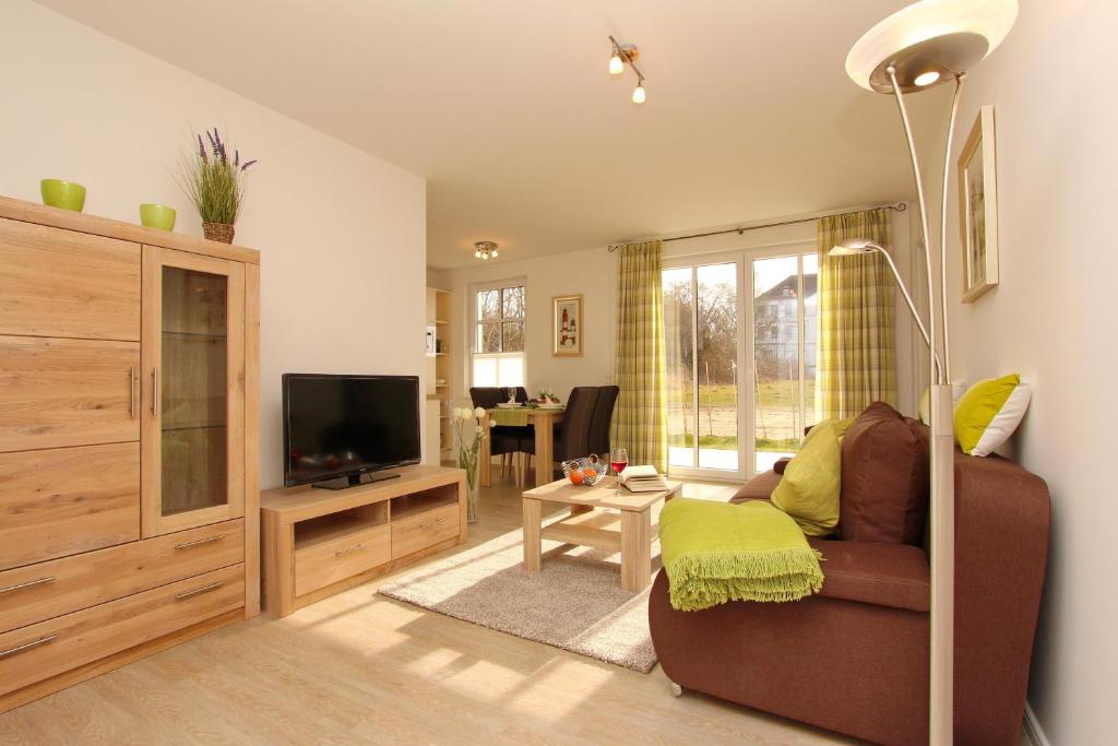 ein Wohnzimmer mit einem Sofa und einem TV in der Unterkunft Residenz von Flotow Wohnung 03 in Heiligendamm