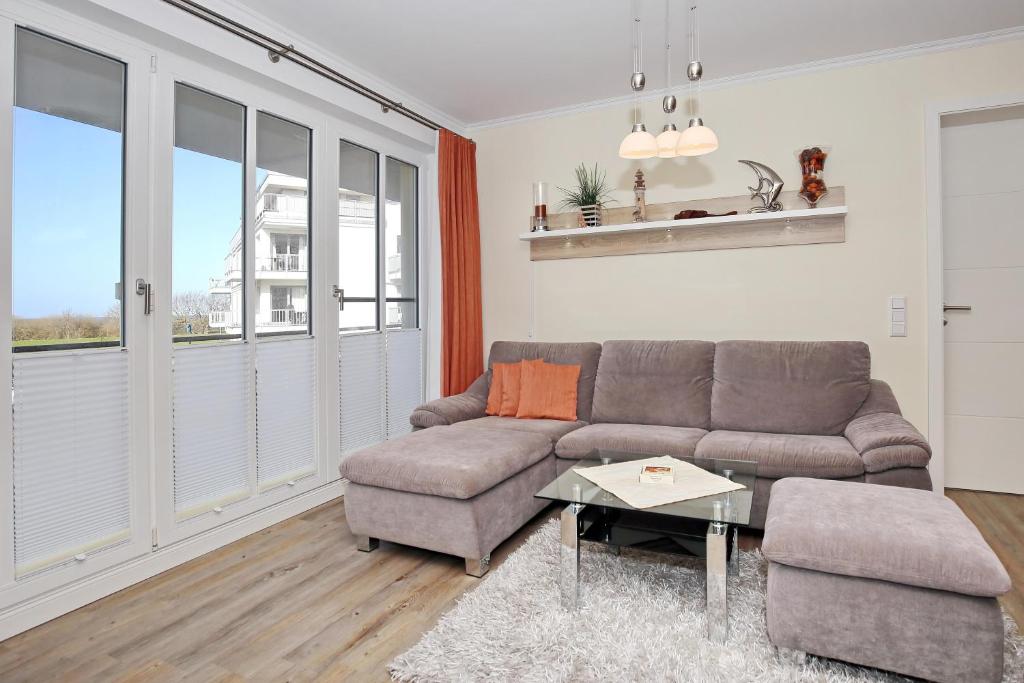 a living room with a couch and a table at Villa Strandvogt Wohnung 11 in Börgerende-Rethwisch