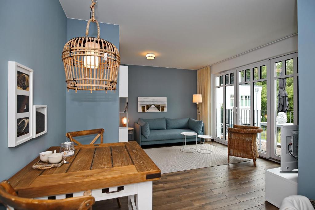 a living room with a table and a couch at Linden-Palais Wohnung 26 in Heiligendamm