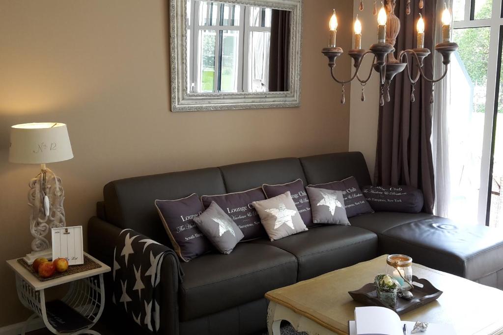 a living room with a couch with pillows on it at Linden-Palais Wohnung 12 in Heiligendamm