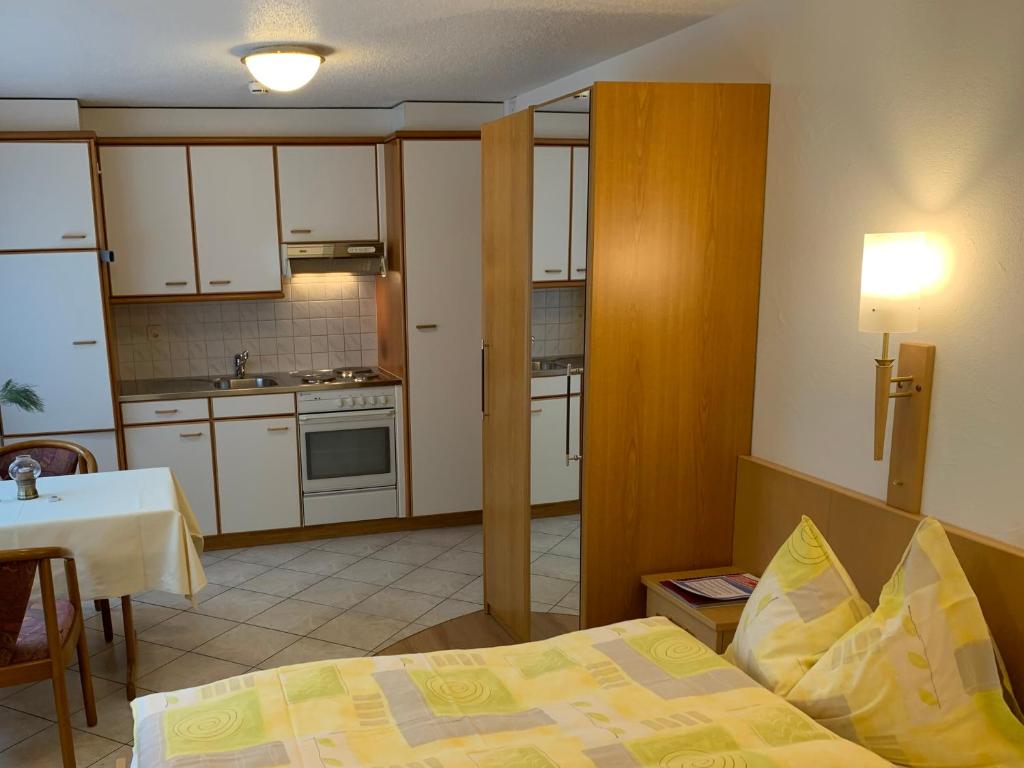 a small room with a bed and a kitchen at Alpenblick in Zermatt