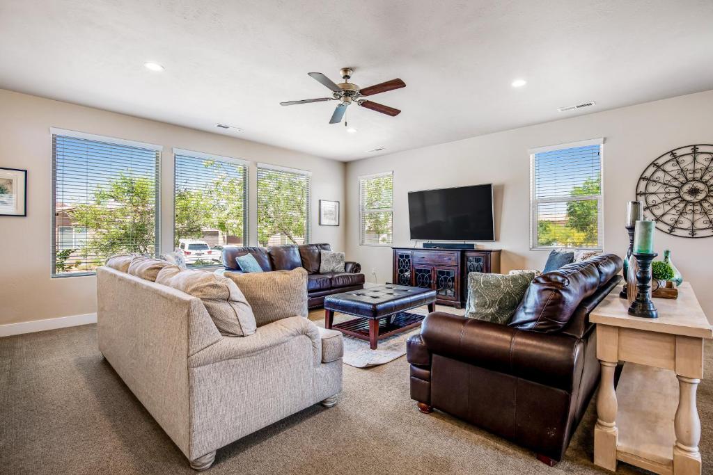 a living room with couches and a flat screen tv at Sunset: Paradise Village #50 in Santa Clara