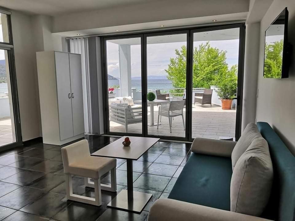 a living room with a couch and a table at Hotel George suite 1 in Limenas