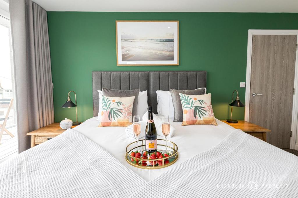 a bedroom with a bed with a plate of fruit on it at BOURNECOAST - STYLISH FLAT with SEA GLIMPSES - FM8406 in Bournemouth