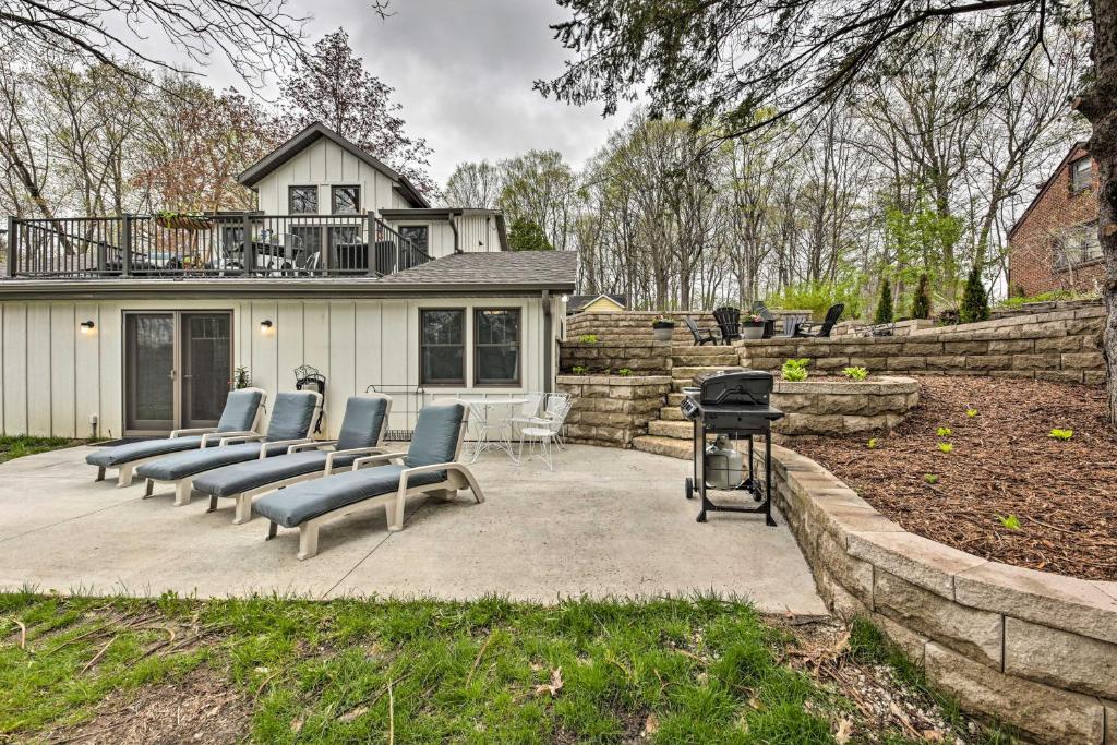 a group of chairs sitting on a patio with a grill at Big Cedar Lake House Views, 100 Ft to Water! in Hartford