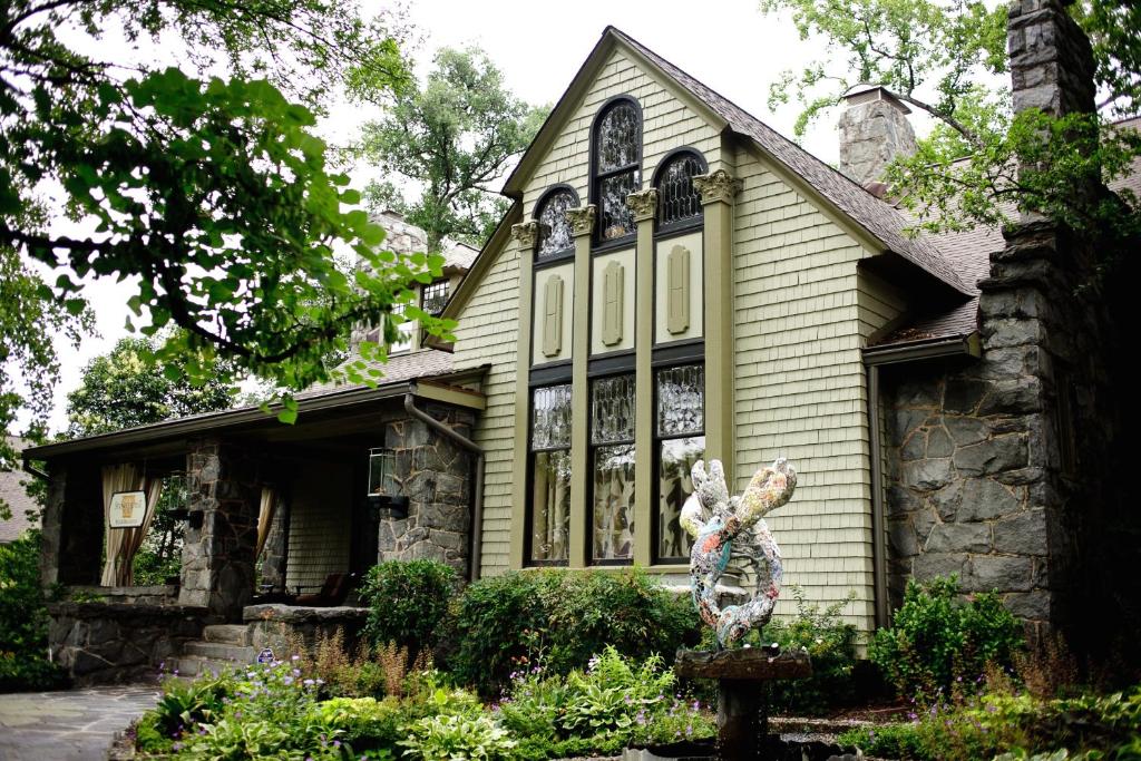 a house with a statue in front of it at Stonehurst Place Bed & Breakfast in Atlanta