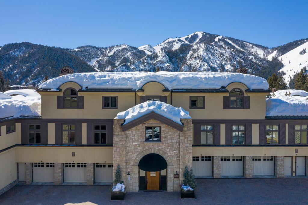 a large house with snow on top of it at Colonnade Residence - 14 in Ketchum