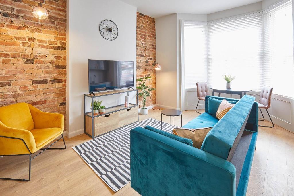 a living room with a couch and chairs and a tv at Host & Stay - North Marine House in Scarborough