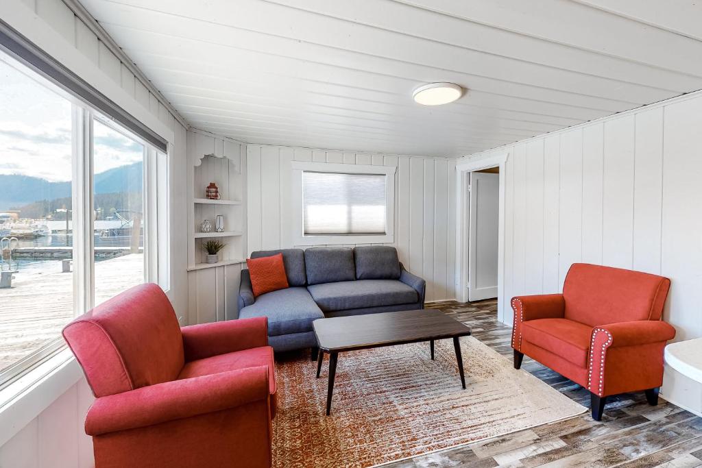a living room with two chairs and a couch and a table at Sitting on the Dock of the Bay in Athol