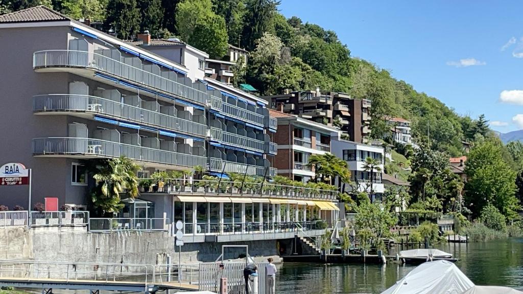 a building on the side of a river at Tresa Bay Hotel in Ponte Tresa