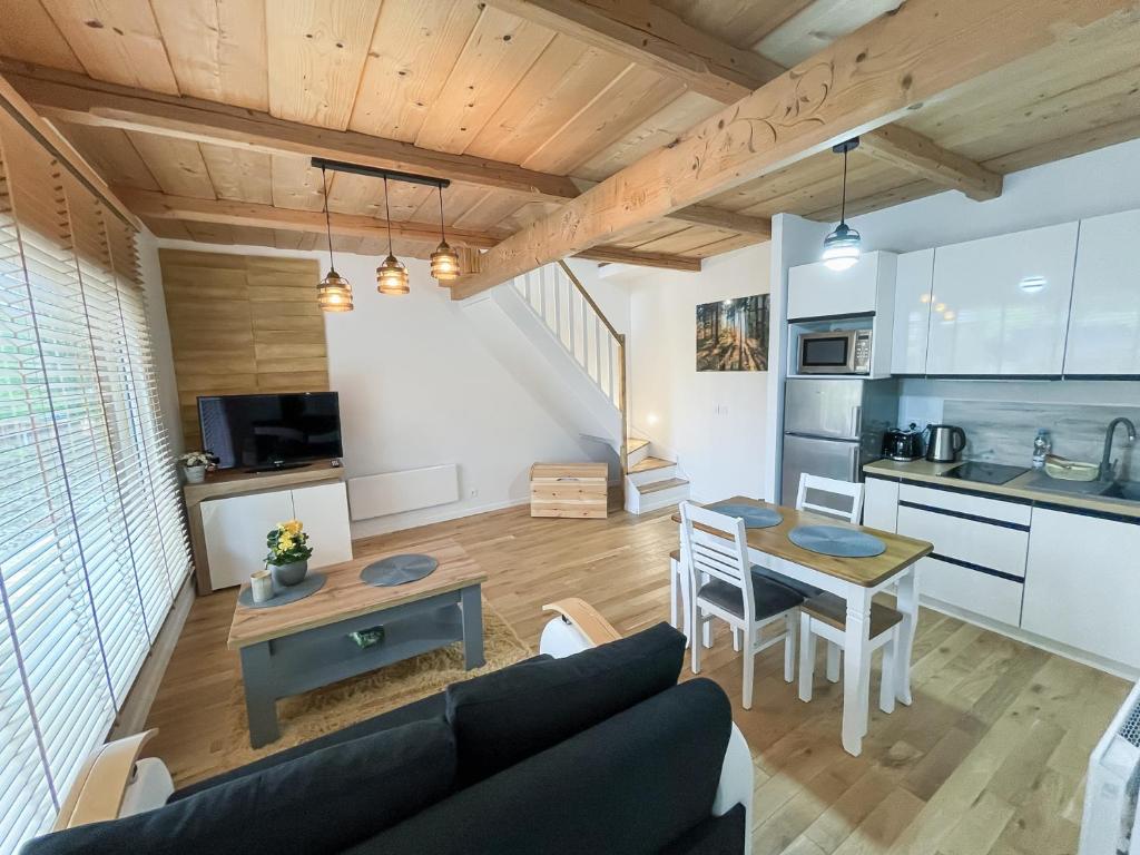 a living room with a couch and a table at Apartamenty rodzinne,NOWE !!! wakacje 2024!! wycieczka rowerowa gratis!!! in Biały Dunajec