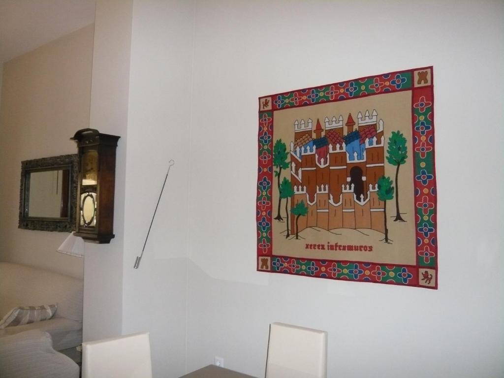 a tapestry hanging on a wall in a living room at Casa Singular , parking gratis in Jerez de la Frontera