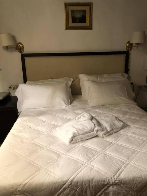 Postel nebo postele na pokoji v ubytování Albergo Le Casaline