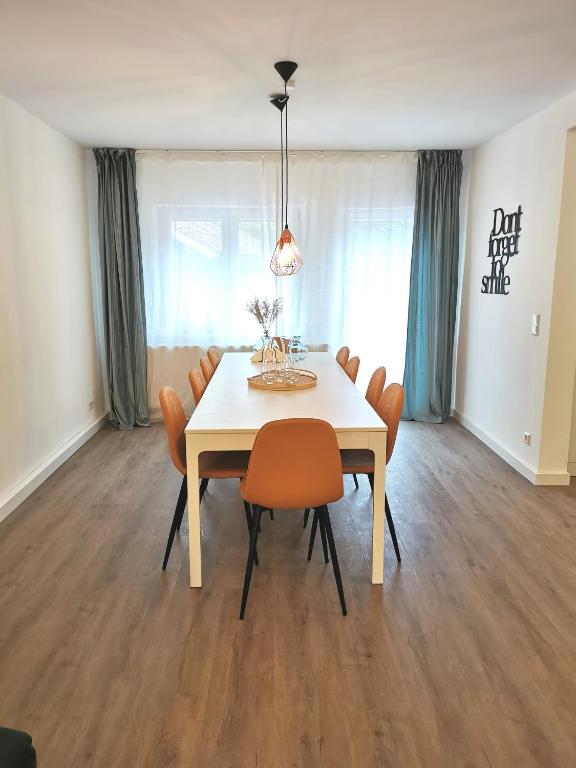 a dining room with a white table and chairs at Ferienhaus Theodor OG in Laufen