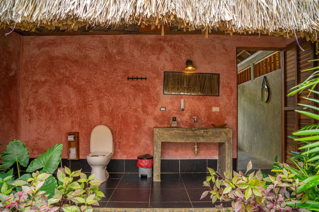 a bathroom with a toilet and a sink at Casa Chapolin Boutique Guesthouse in Palomino